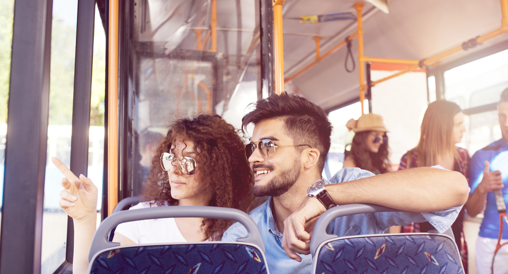 Smiling young couple in a bus.